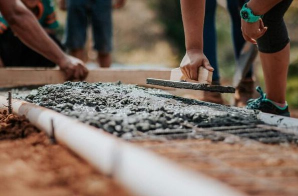 workers putting concrete cement